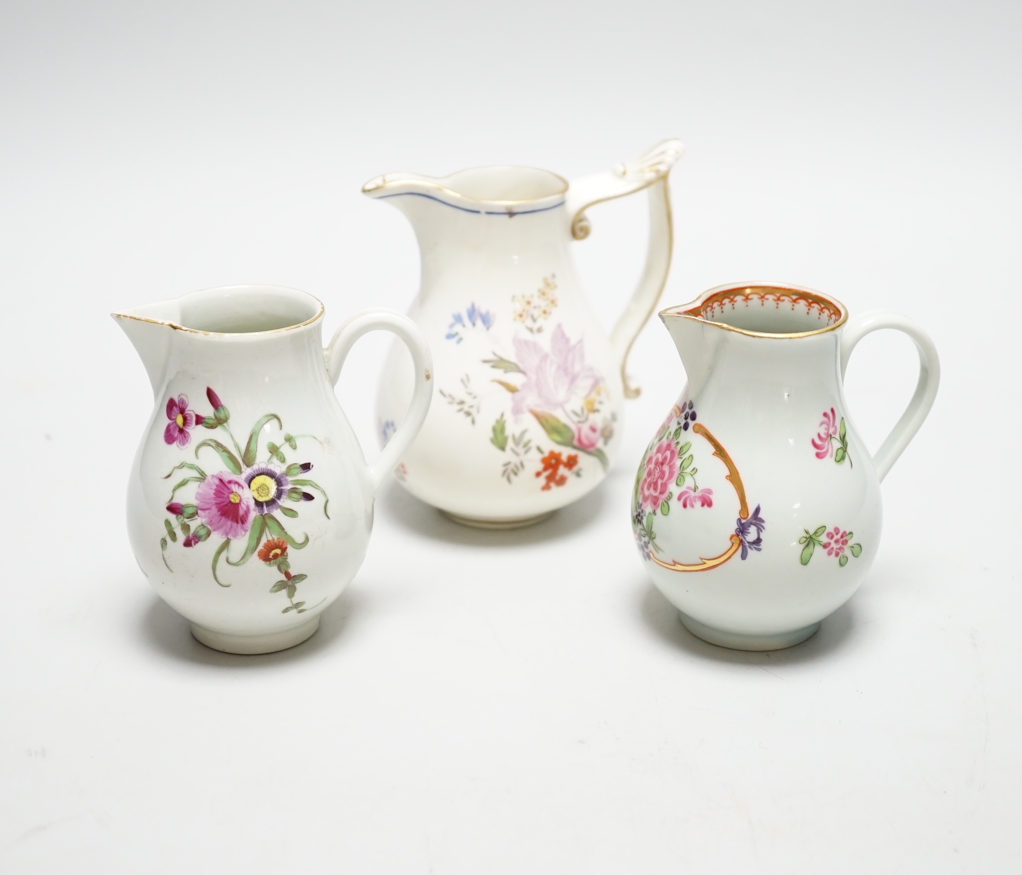 Two Worcester flower painted sparrow-beak jugs, c.1780 and an English porcelain milk jug, c.1825 (3)
